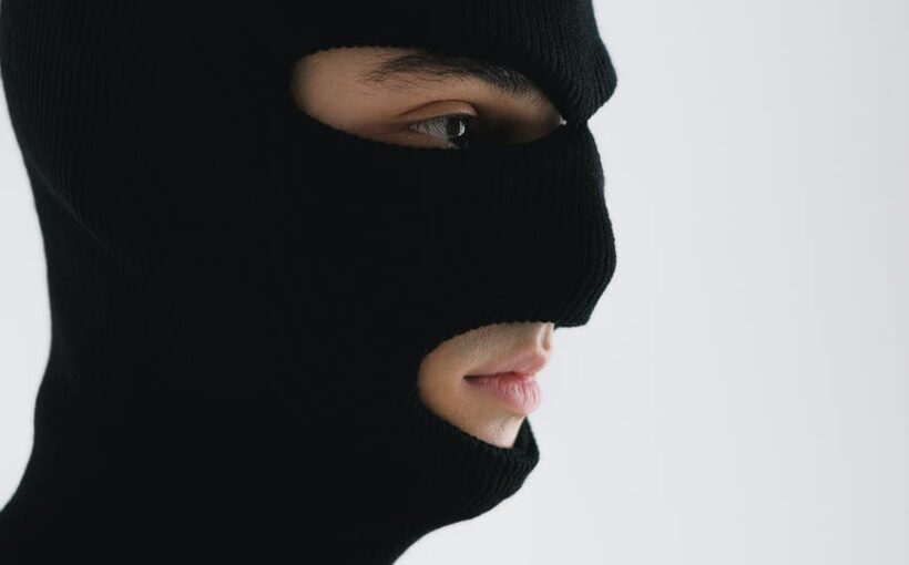 close up shot of a person wearing a robber mask