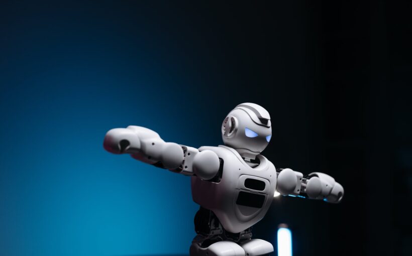 close up shot of white toy robot on blue background