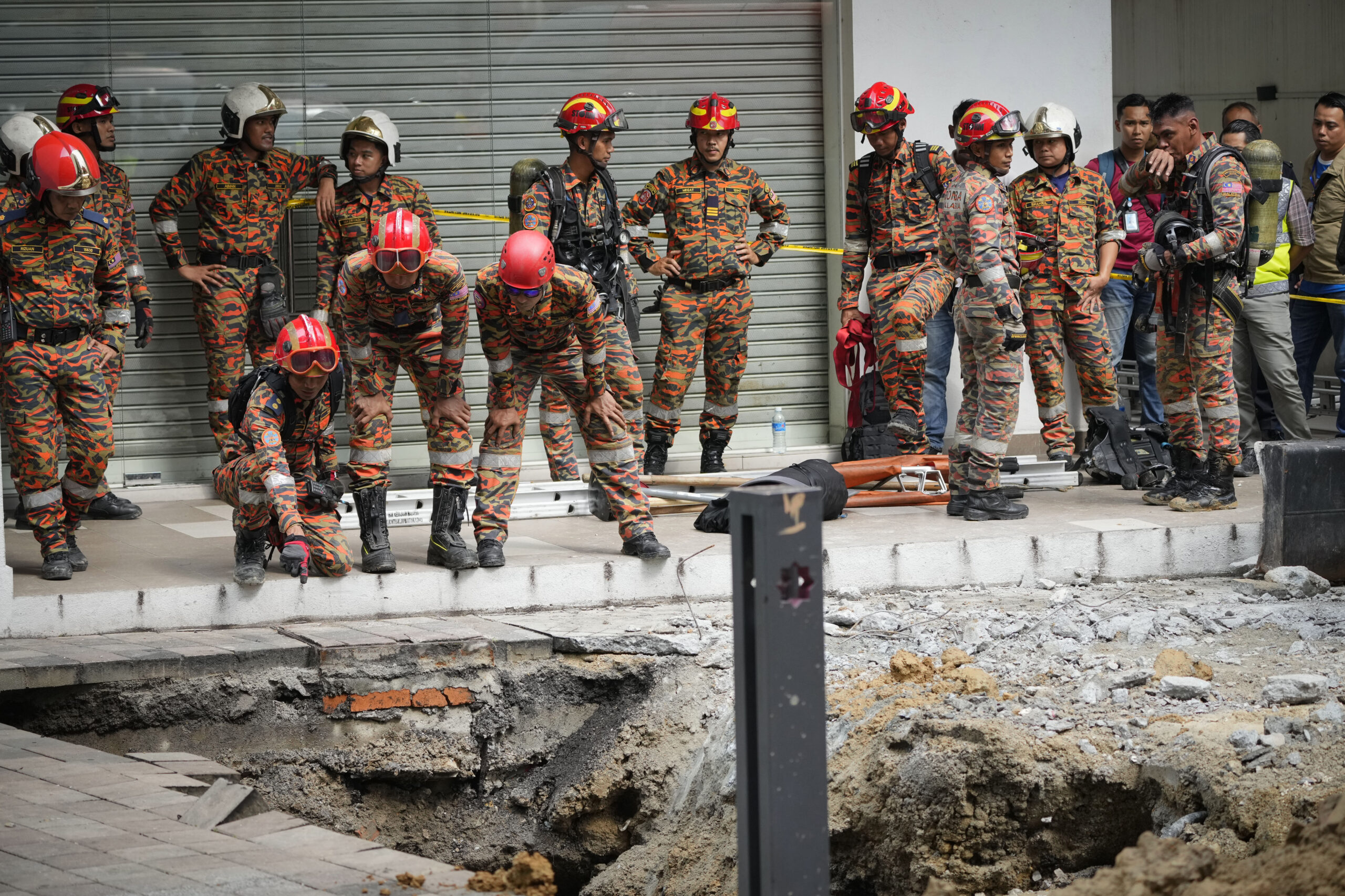 Woman plunges into an eight-metre-deep hole after pavement sinks in Malaysia