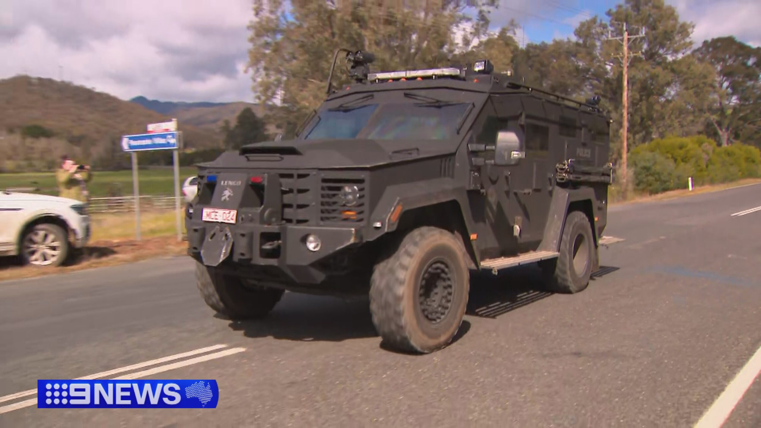 Homes raided as manhunt for accused cop killer continues